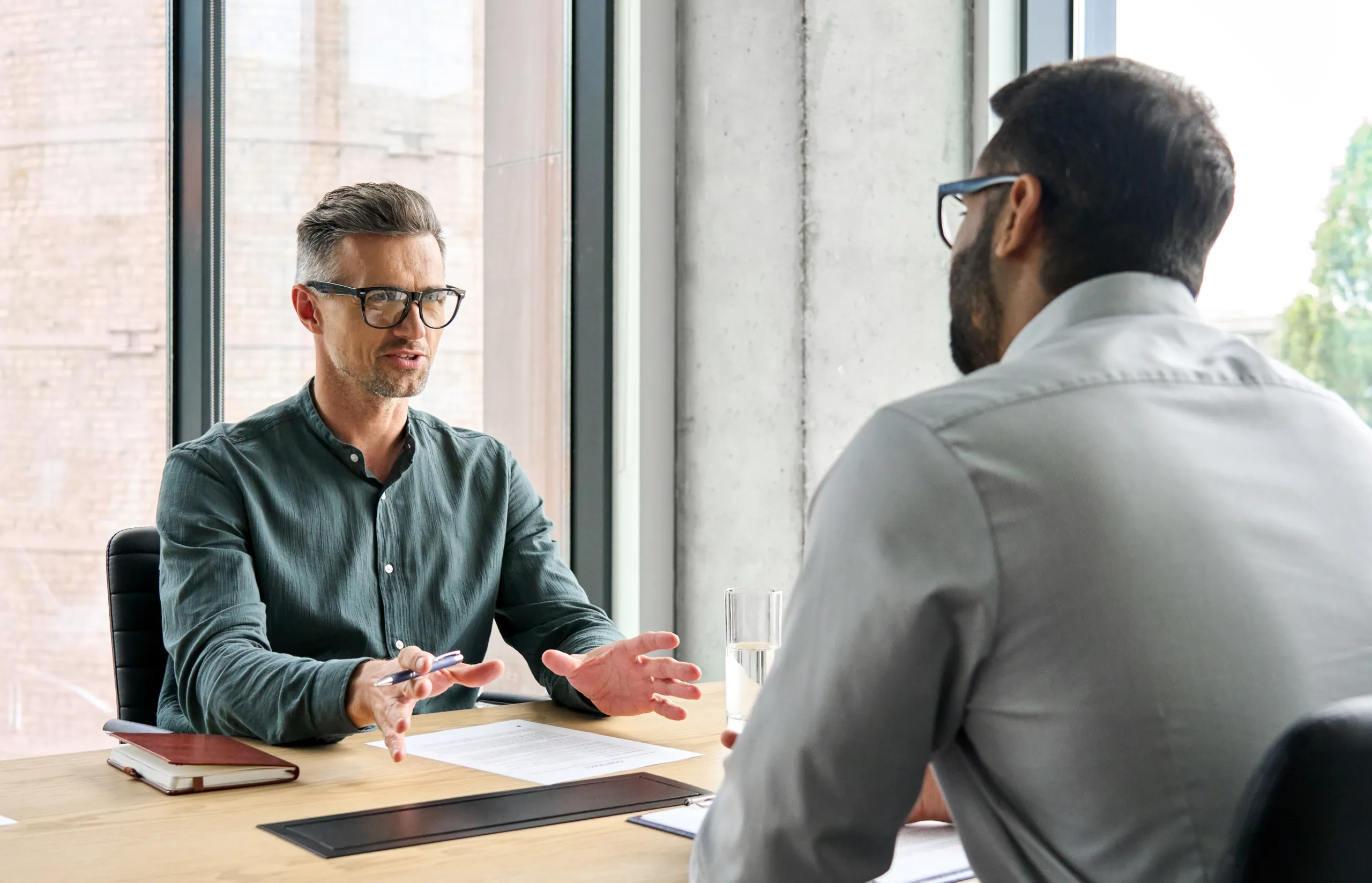 Manager adviser consulting client discussing financial partnership at meeting. manager adviser consulting with client