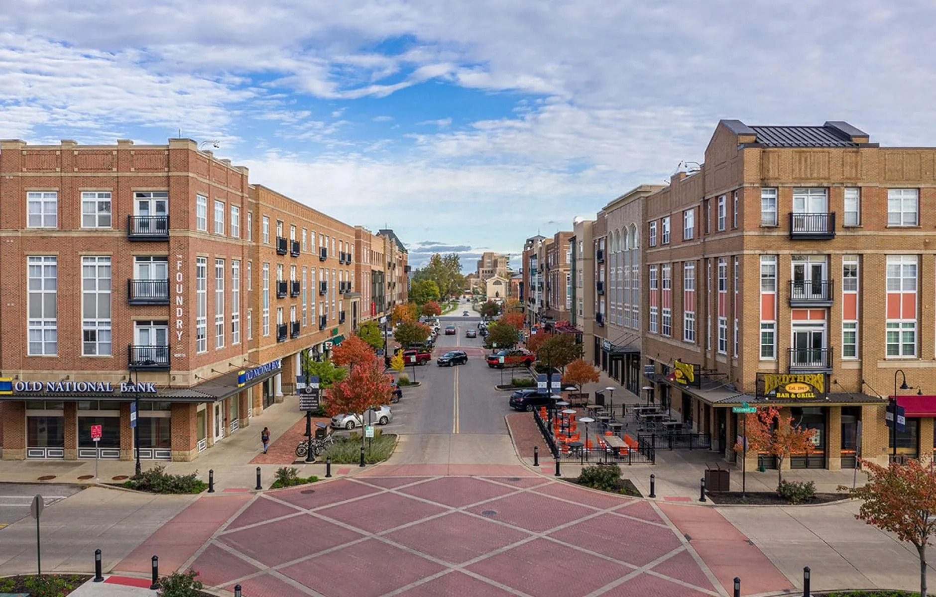 South Bend-min Aerial view of a downtown South Bend Indiana street lined with brick buildings and shops