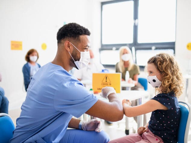 Child with face mask getting vaccinated, coronavirus, covid-19 and vaccination concept.