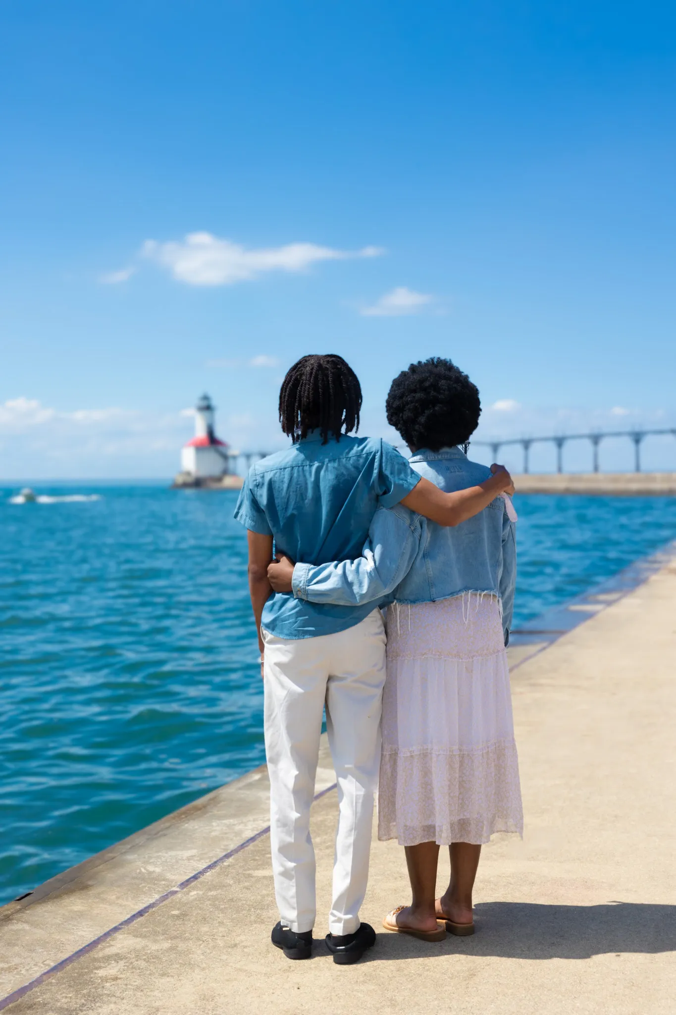 Couple standing by lighthouse in Michigan City, Indiana